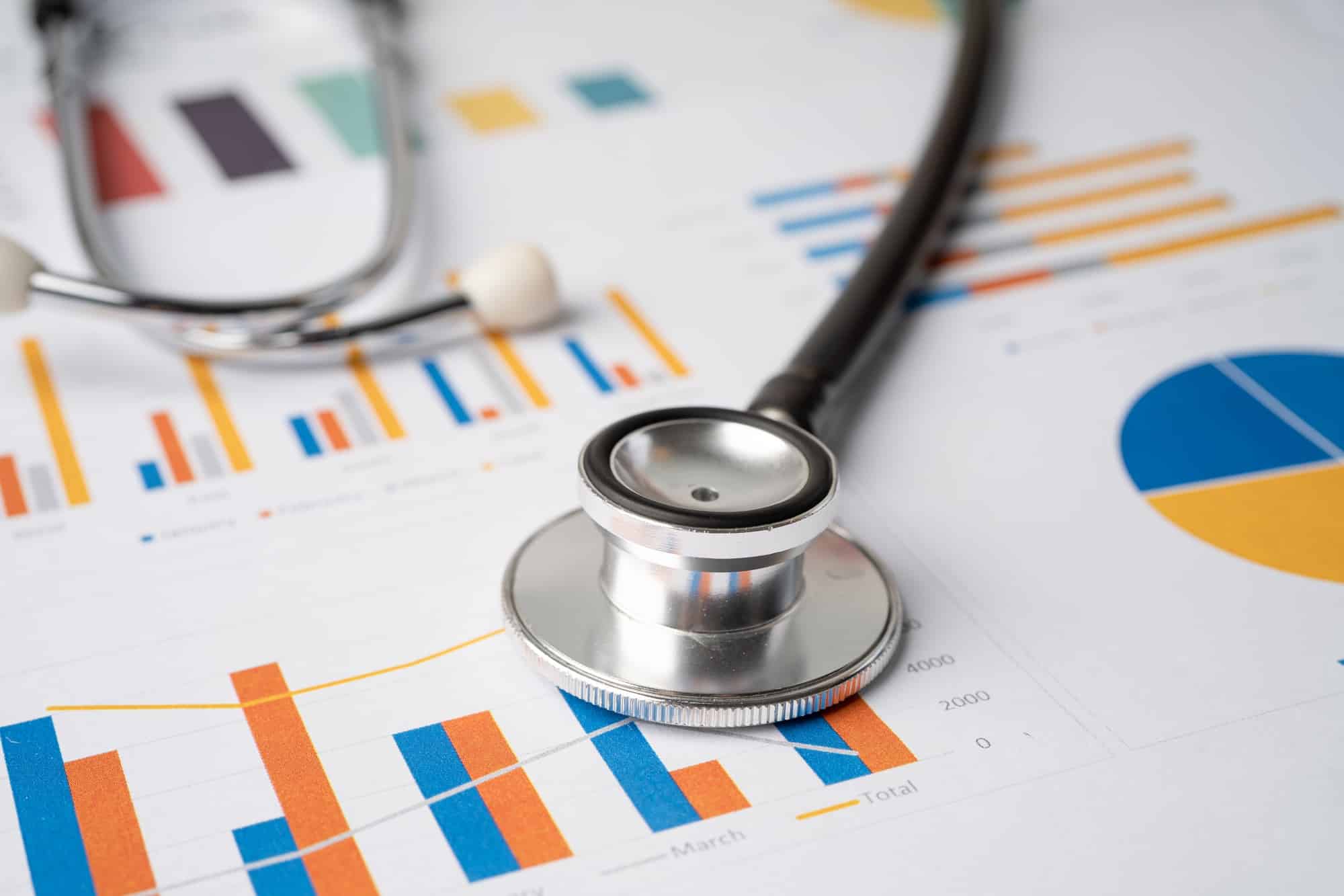 Stethoscope on charts and graphs paper.