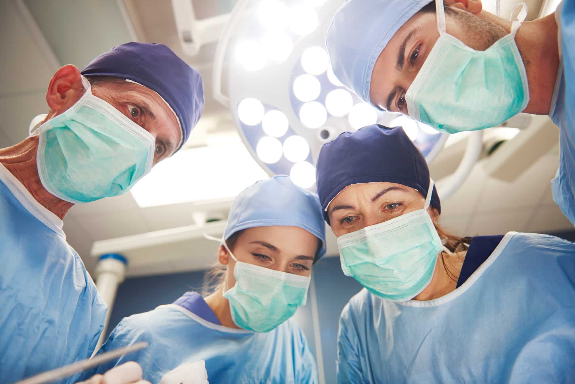Team of surgeons over the operating table